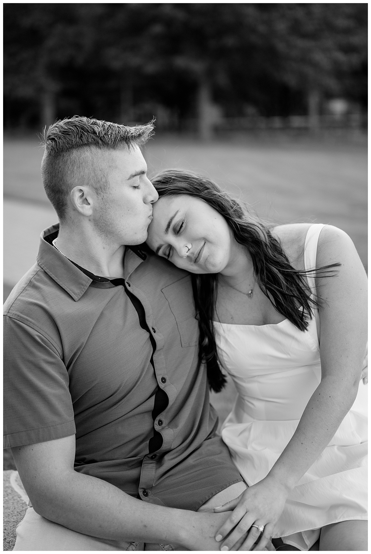 brunette woman leans on man's shoulder by Minnesota wedding photographer 