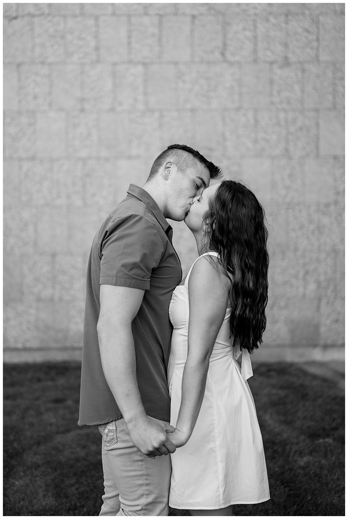 wife-to-be kisses her fiancé for playful St. John's engagement shoot