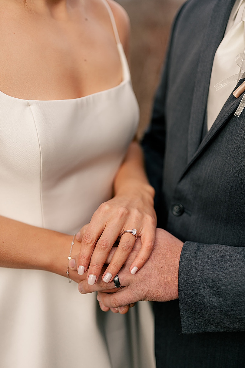 couple shows off their new rings by Minnesota wedding photographer