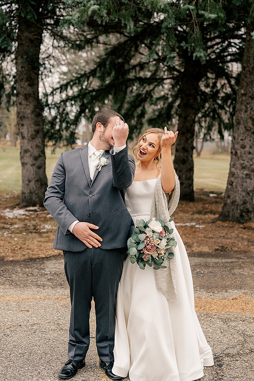 newlyweds show off their new rings before ceremony by Minnesota wedding photographer