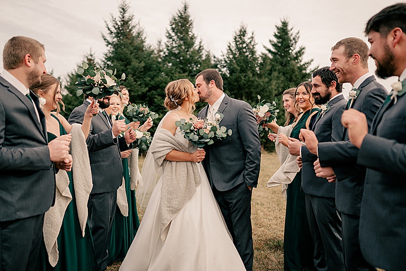 newlyweds kids next to bridal party in Romantic Winter Wedding in Brooten