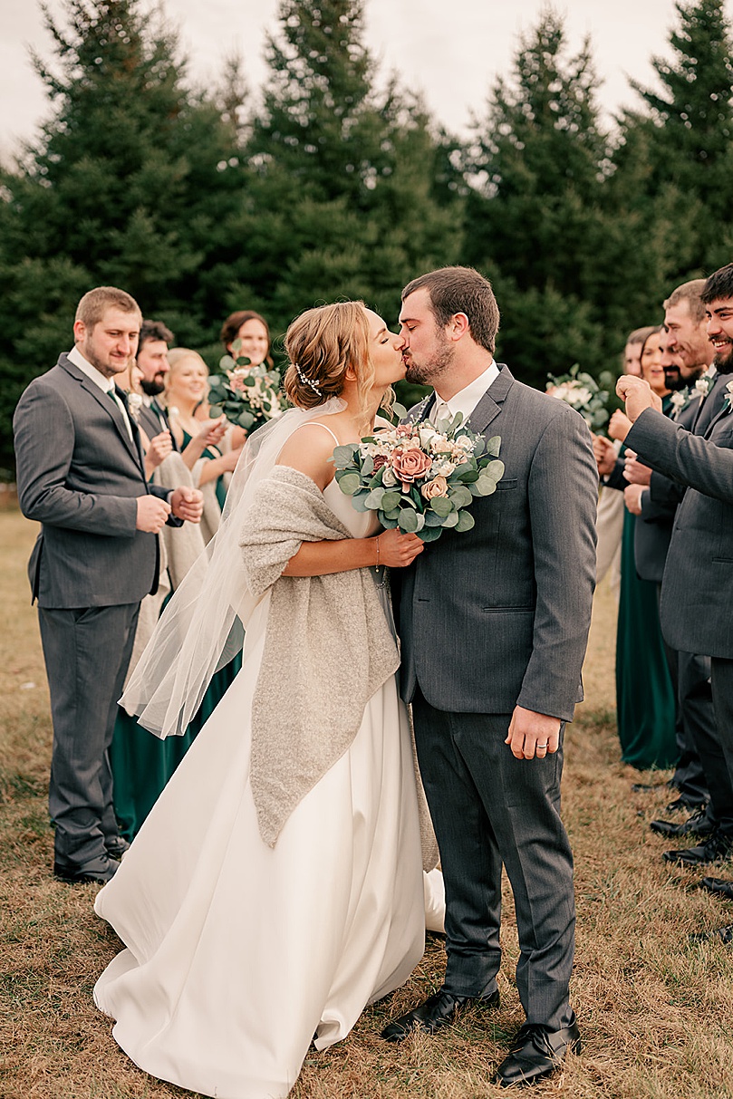 man and woman share a kiss outside by Minnesota wedding photographer