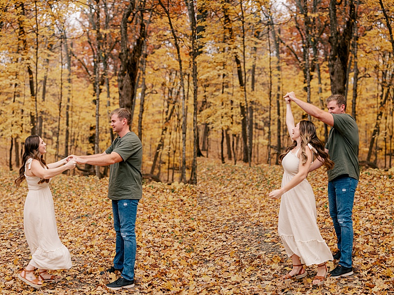 man spins his girl in fall leaves by Rule Creative Co