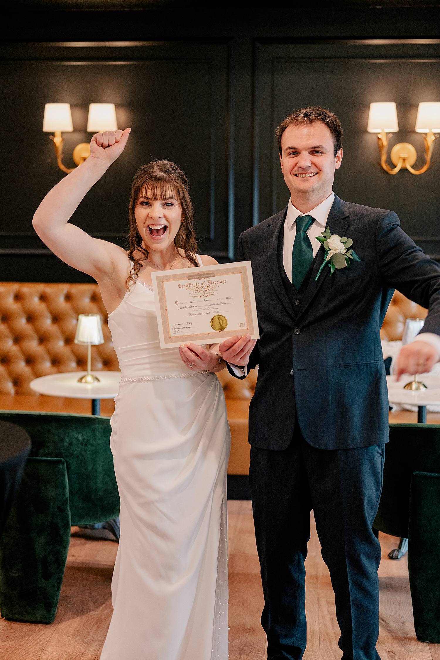 man and wife hold up certificate of marriage by Minnesota wedding photographer