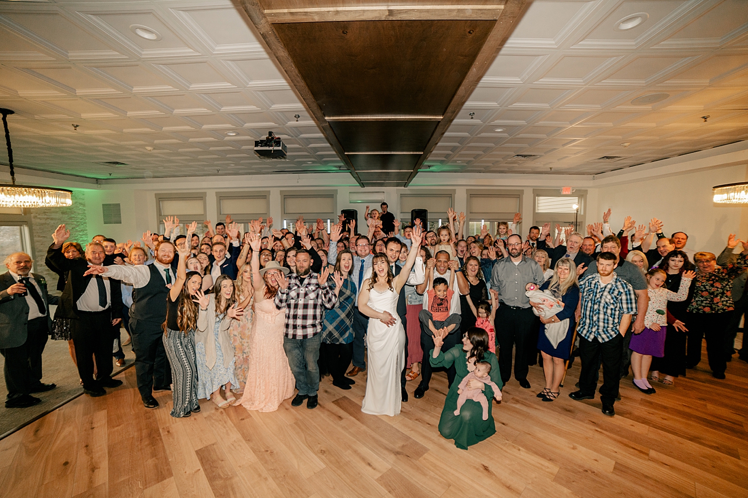 guests all gather in group on dance floor by Minnesota wedding photographer