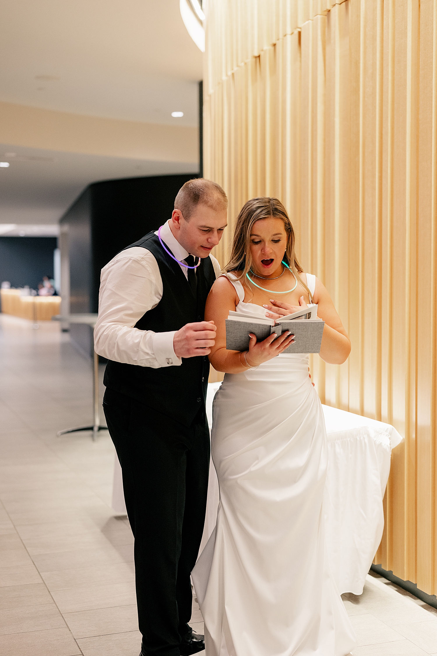 newlyweds look at guest book fondly at Holy Name of Jesus Catholic Community