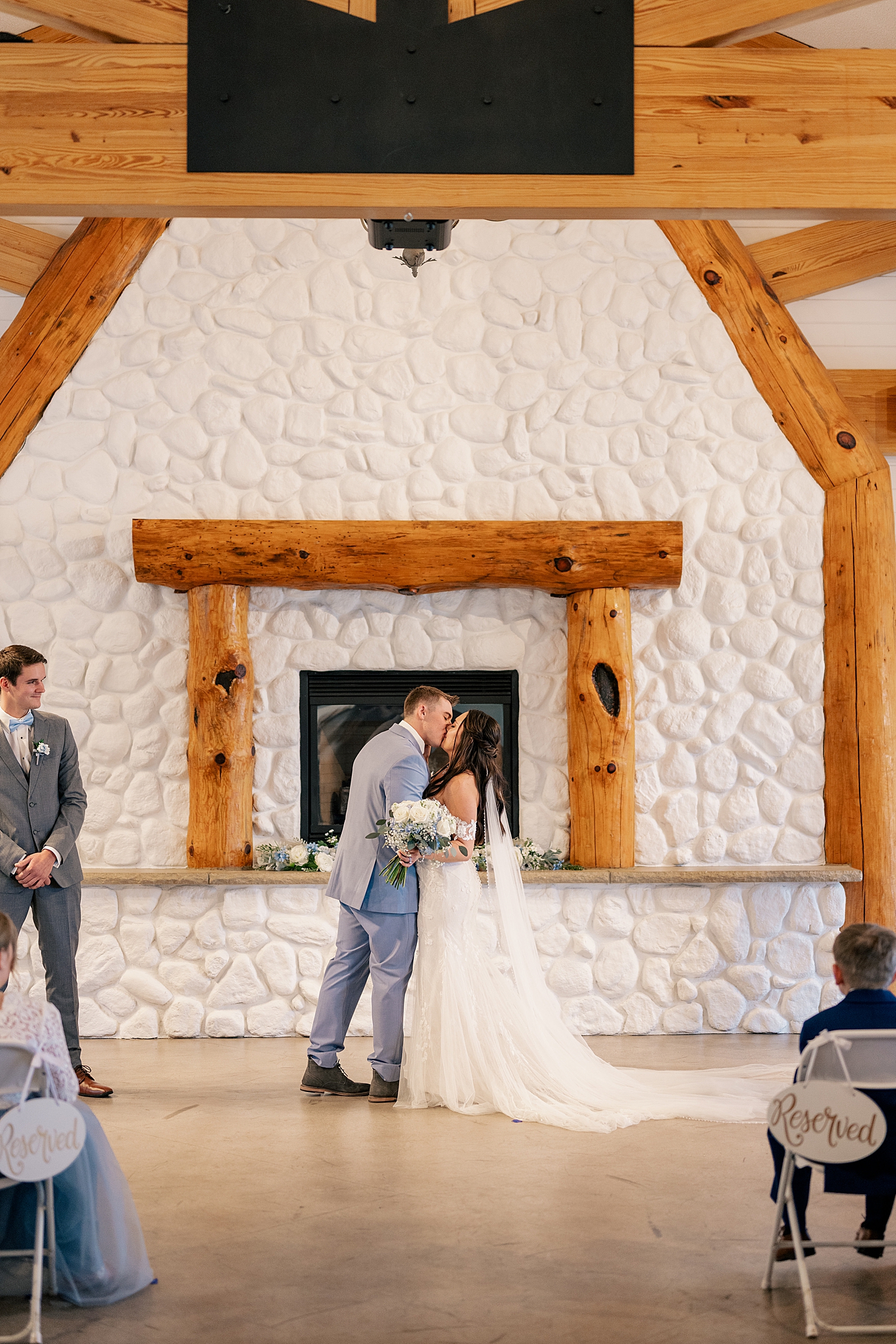 newlyweds share kiss at alter by Minnesota wedding photographer
