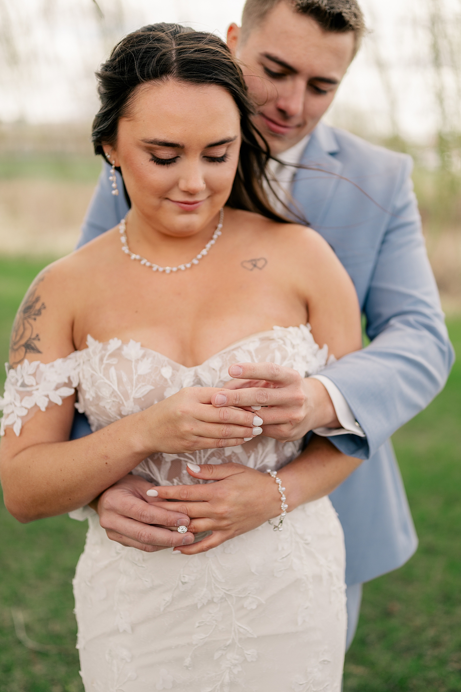 man wraps up his wife and hold her hands by Rule Creative Co
