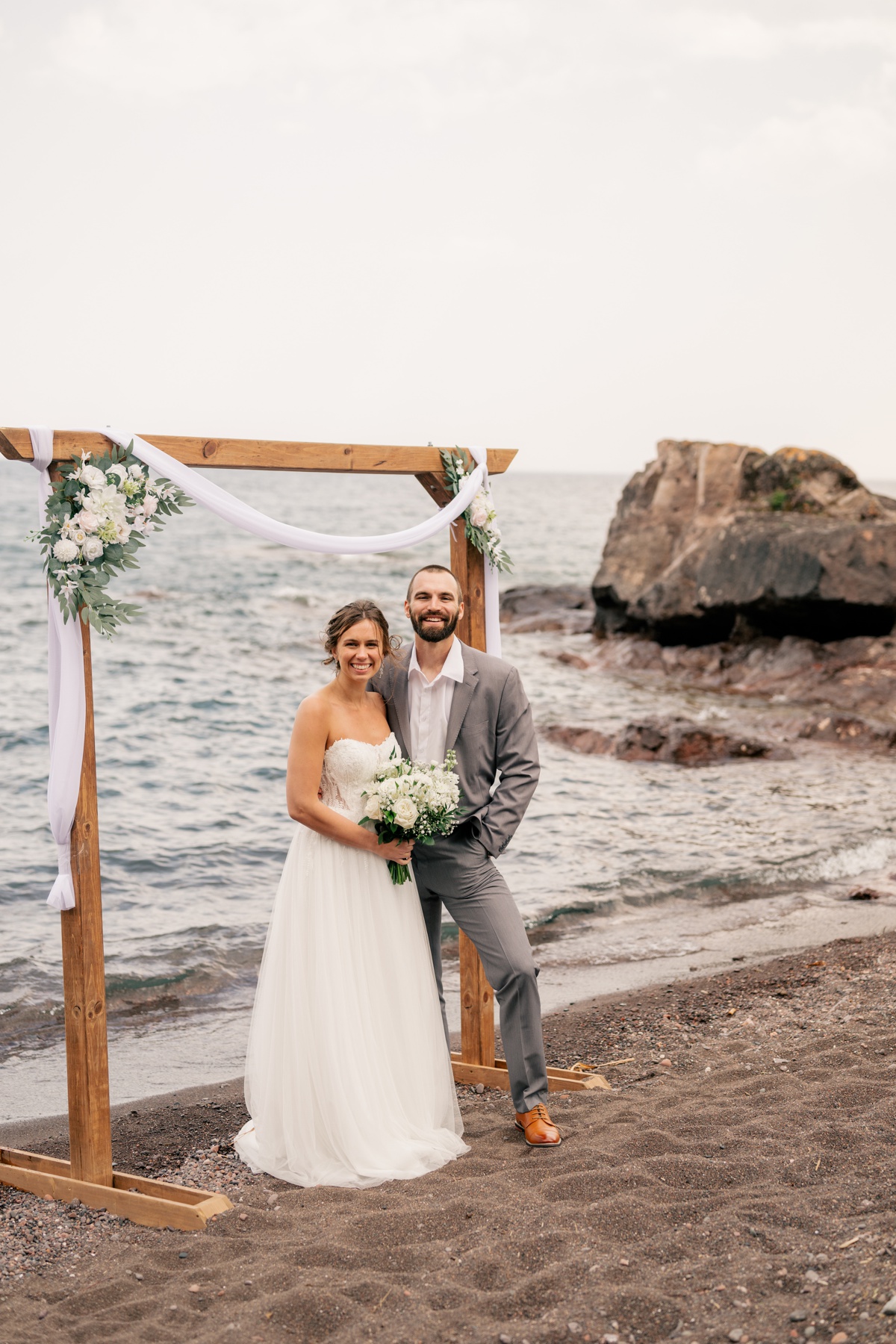 Couple poses under archway by Rule Creative Co.