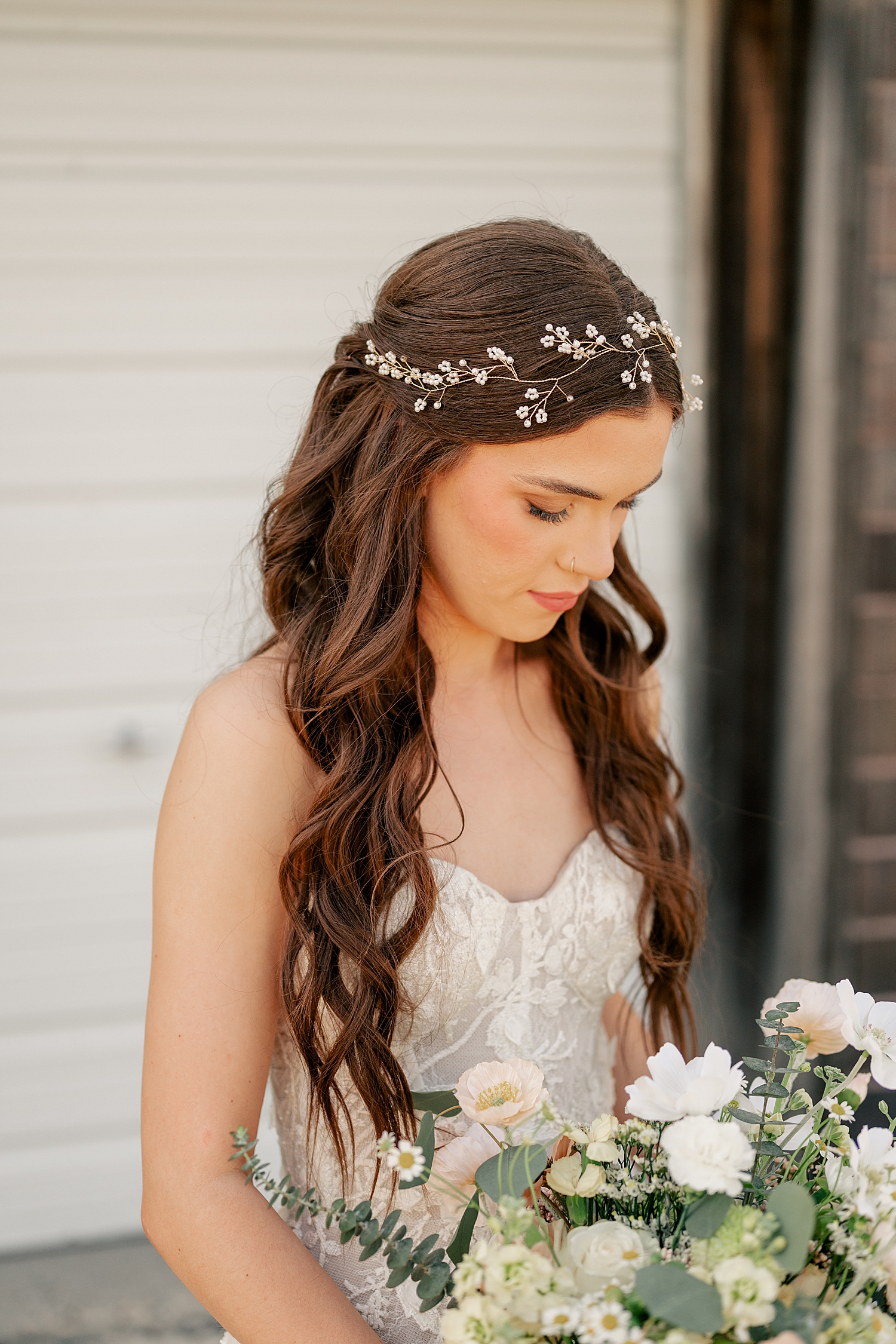 brunette with pearl wire floral headband looks down at The Cottage Farmhouse