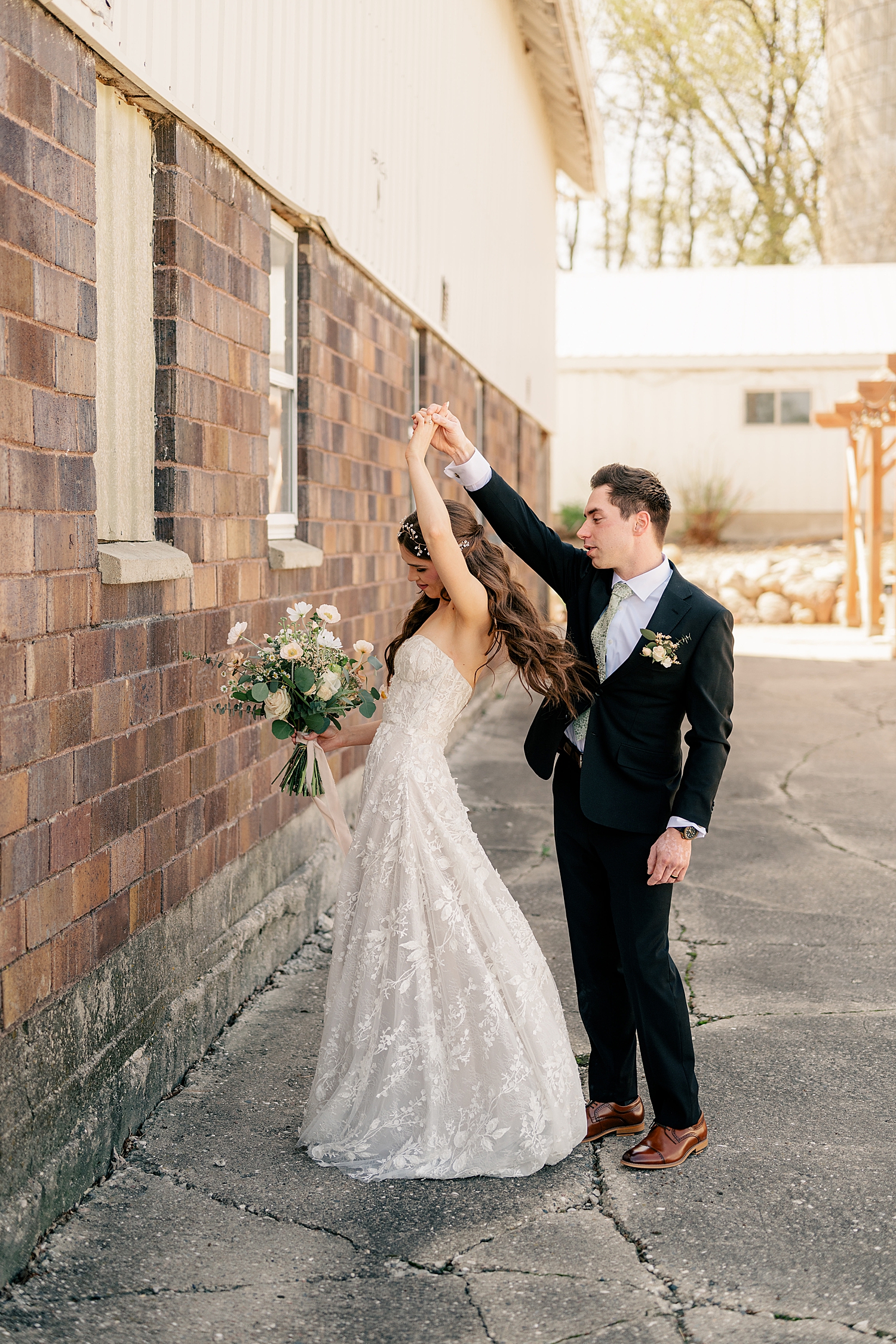 man spins his bride to be at The Cottage Farmhouse