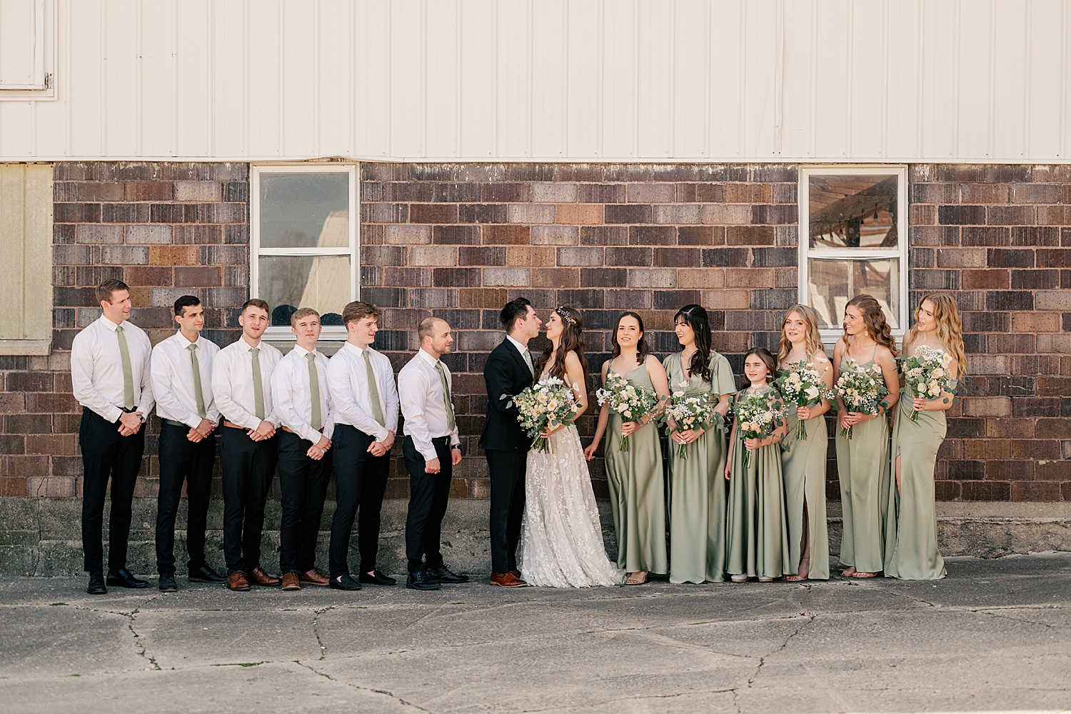 wedding party stands next to bride and groom by Rule Creative Co