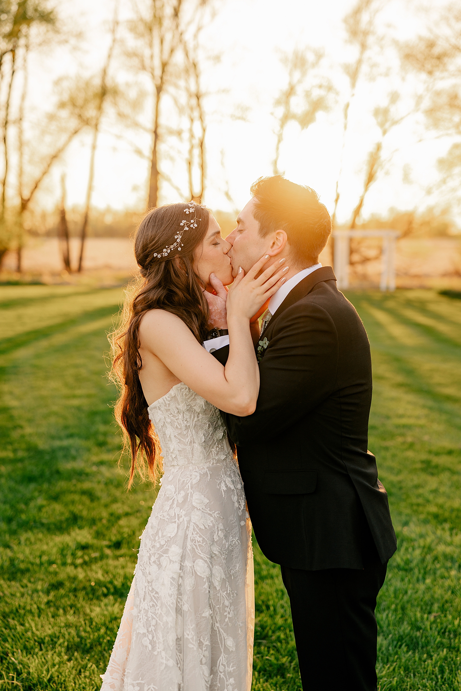 husband and wife share a kiss in golden hour by Rule Creative Co