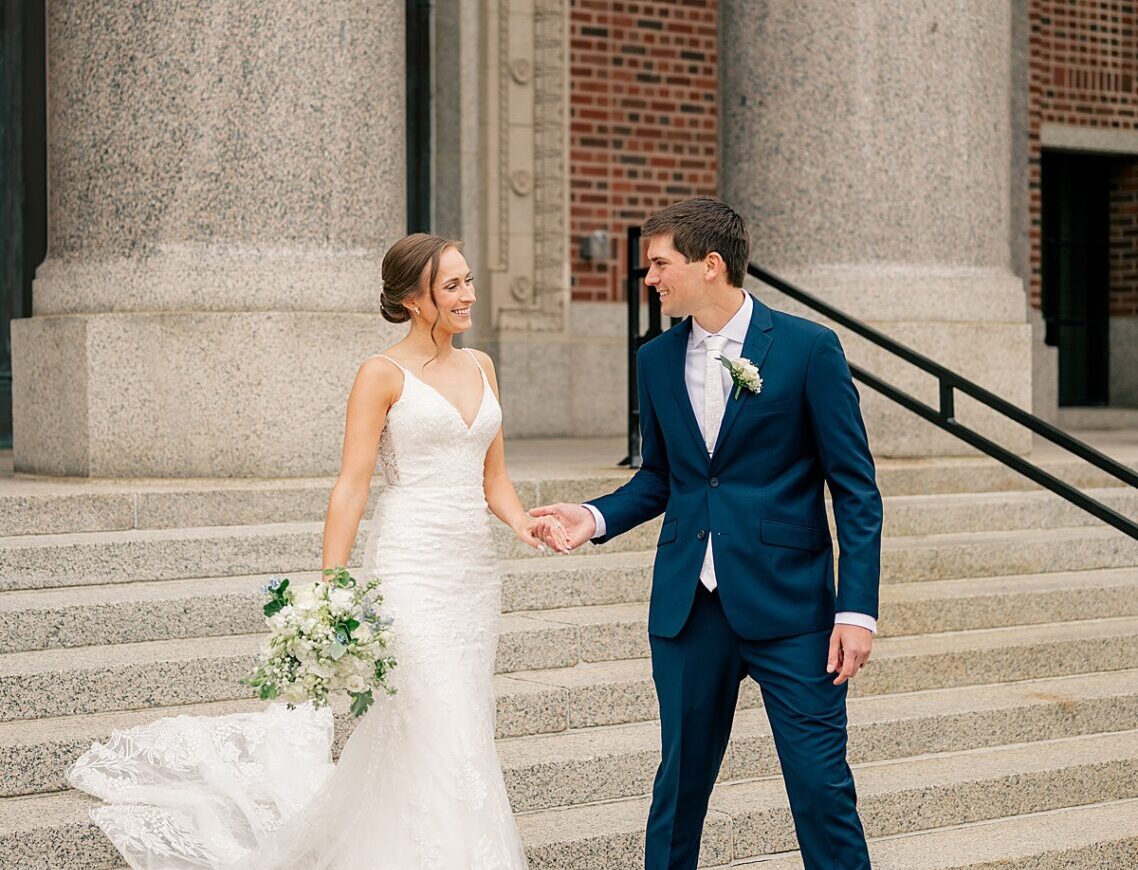 Bride and Groom walk down staircase together by Rule Creative Co