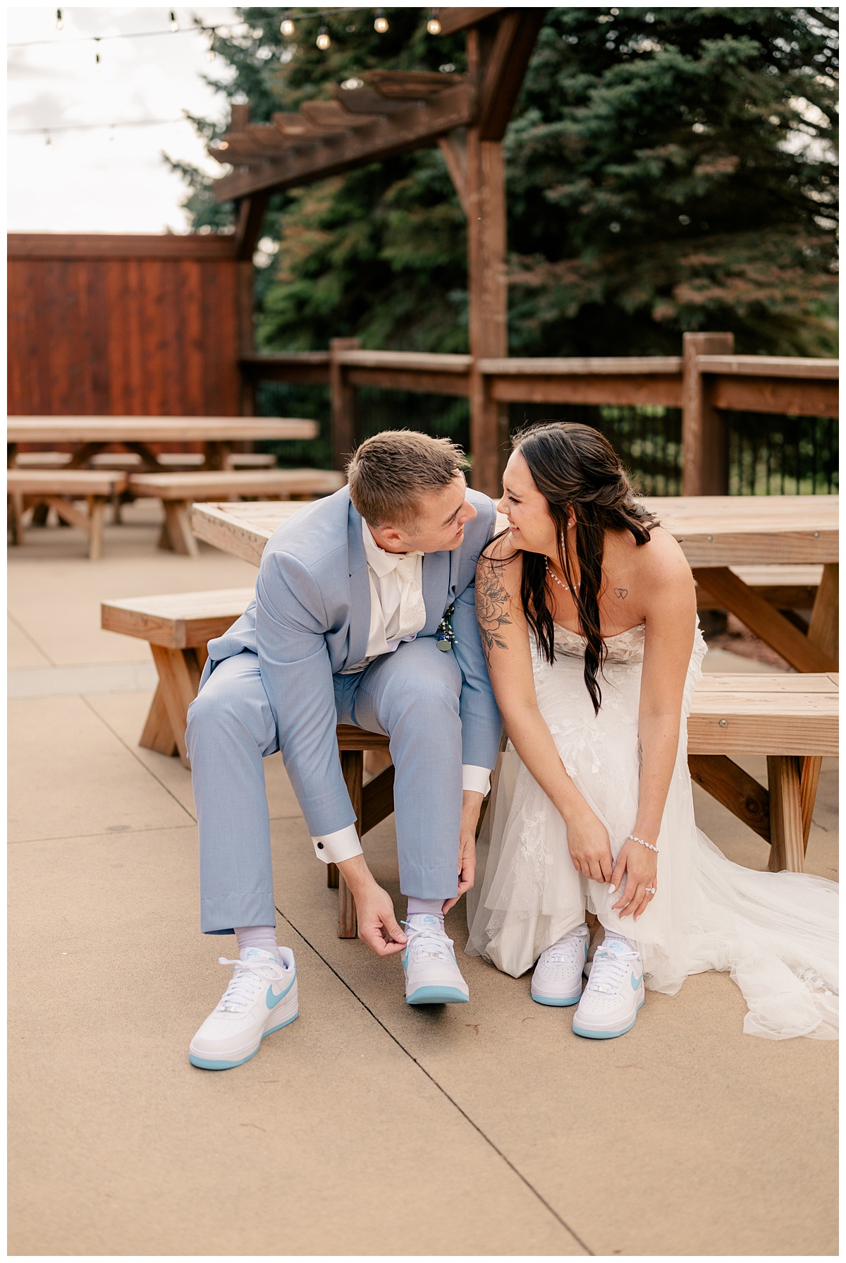 Right Image shows a bride and groom sitting on a picnic table bench, smiling and looking at one another while putting on matching Nike shoes.
