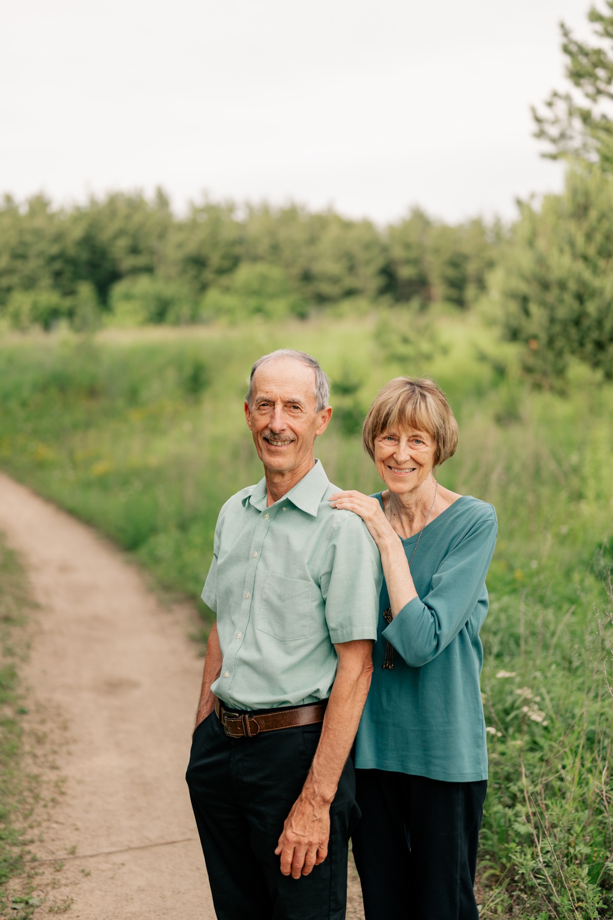 Elderly couple standing and smiling during Anniversary Mini Session