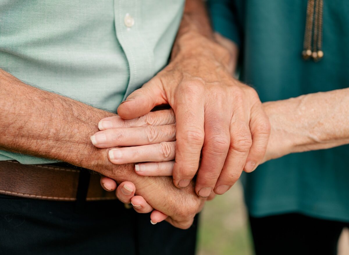 Man and woman hold hands during Anniversary Mini Session