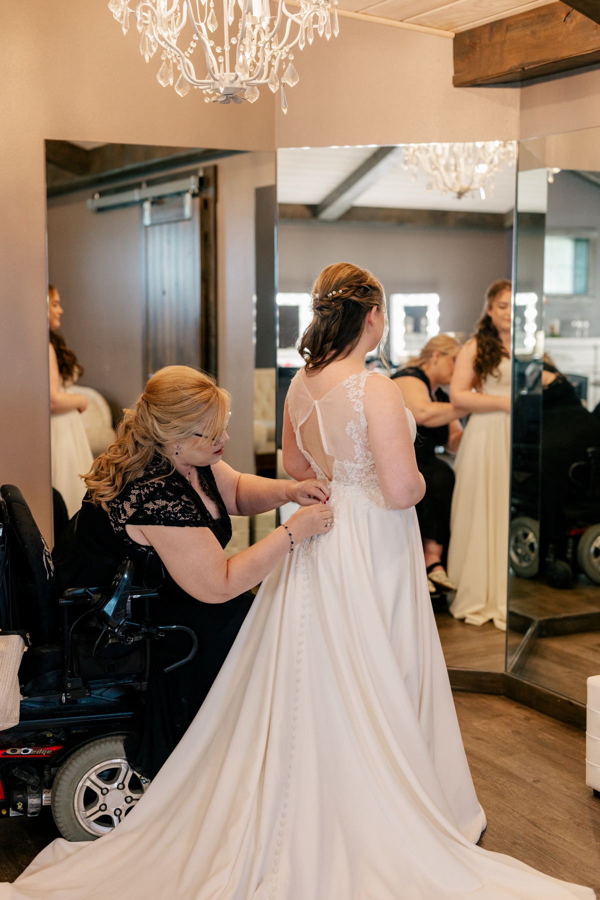 Mother buttons up daughters wedding dress by Rule Creative Co