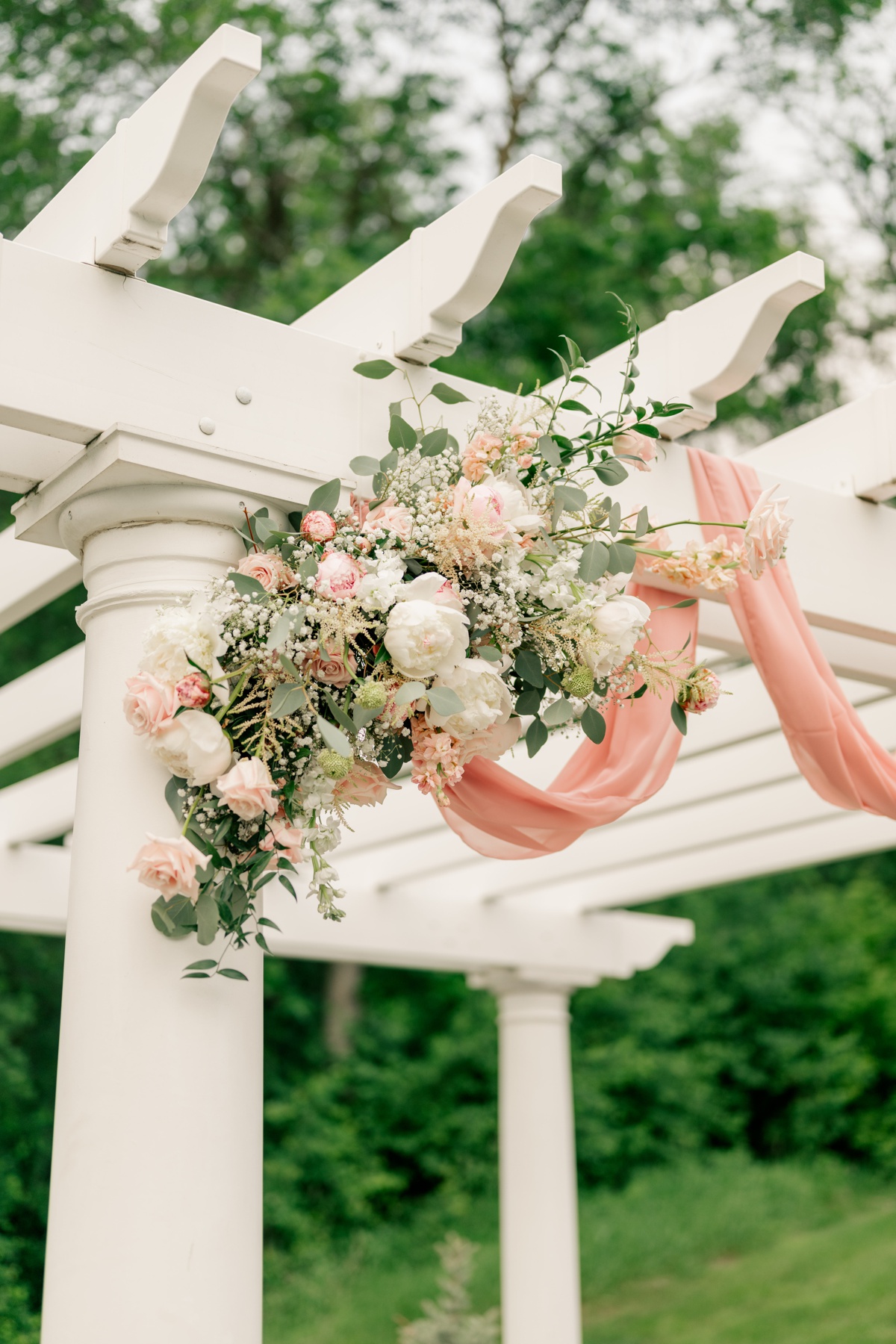 Pink and white wedding floral on ceremony arch by Rule Creative Co