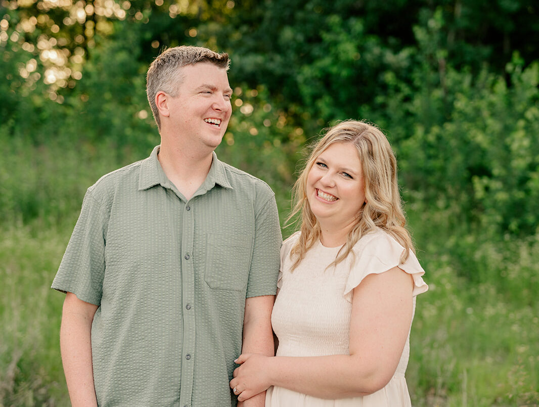 Couple holding hands in park during Joyful Engagement Session
