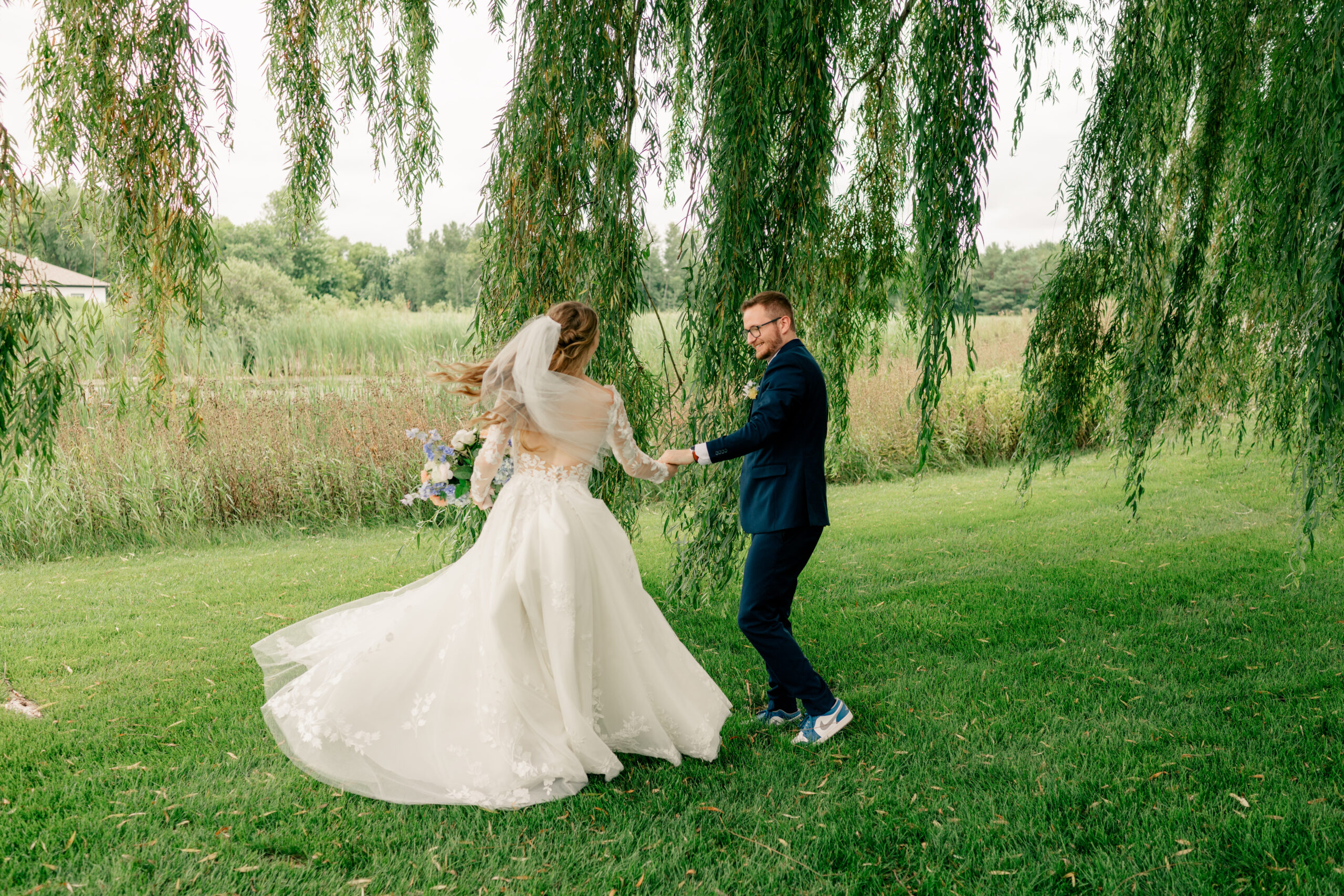 Bride and groom dance under weeping willow tree by Rule Creative Co.