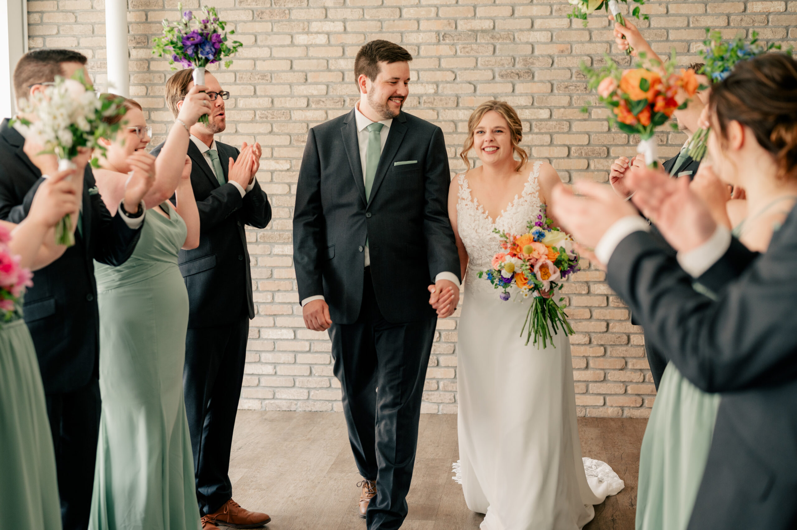 Bride and Groom celebrate with wedding party by Rule Creative Co