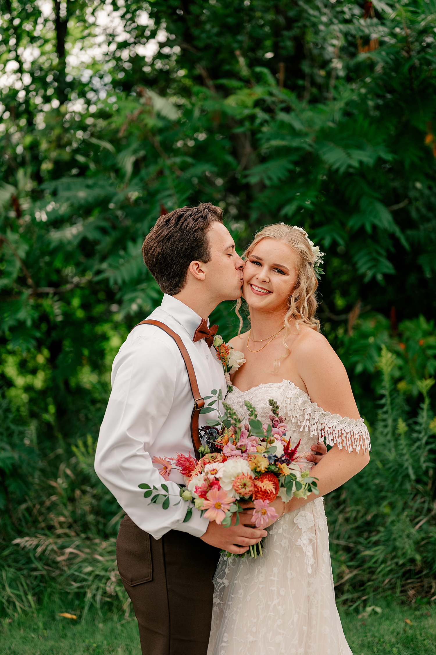 groom leans in to kiss his bride after first look at Gale Woods Farm