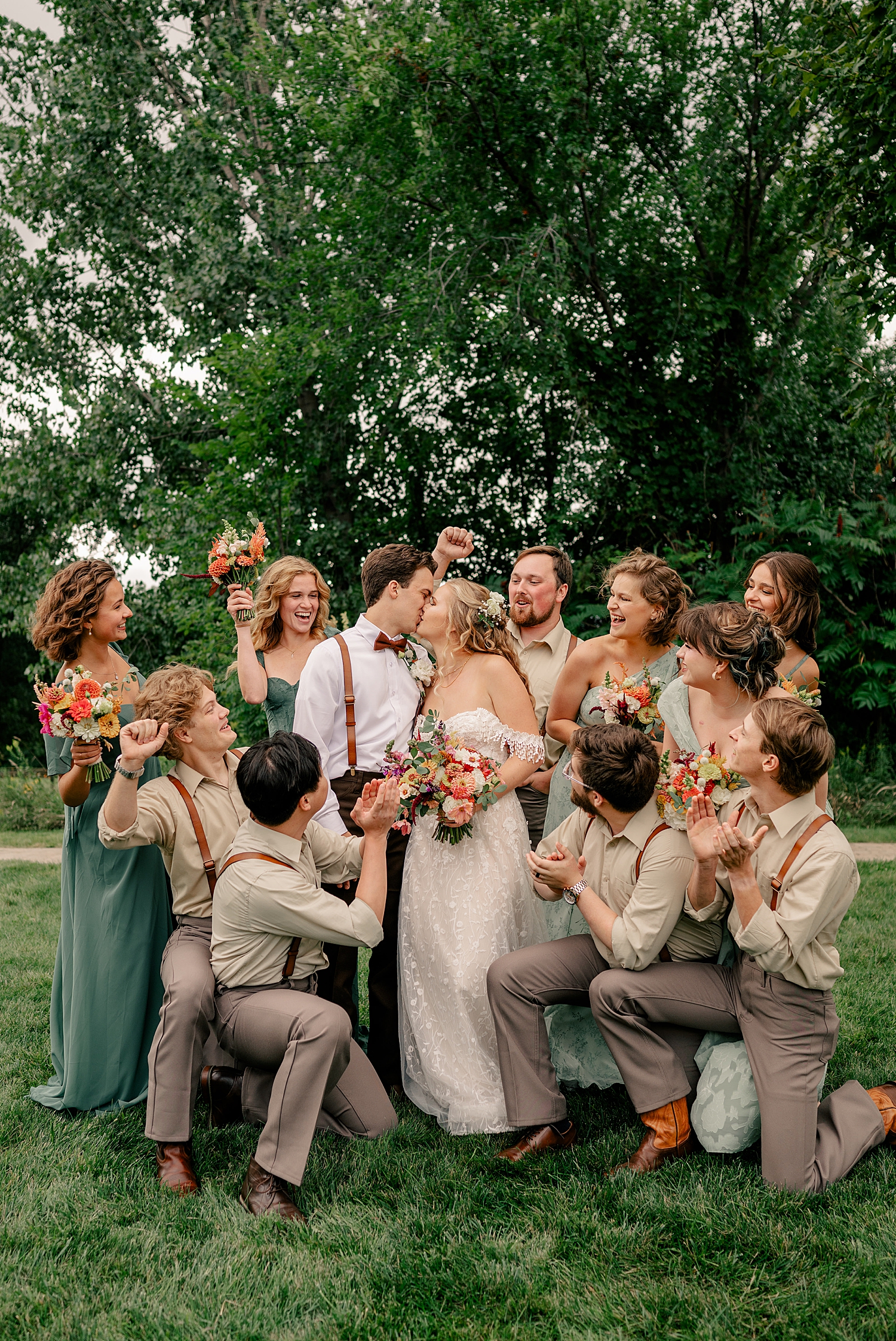 bridal party surrounds couple outside on a field by Rule Creative Co