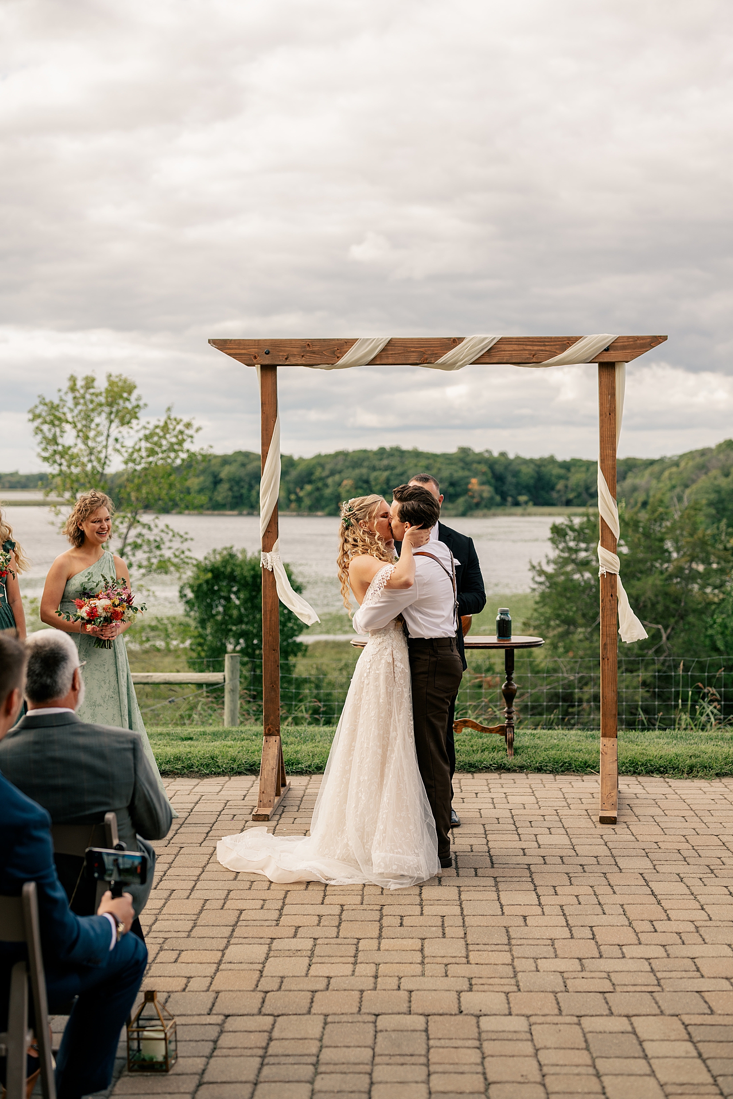 newlyweds share a kiss under alter at Gale Woods Farm