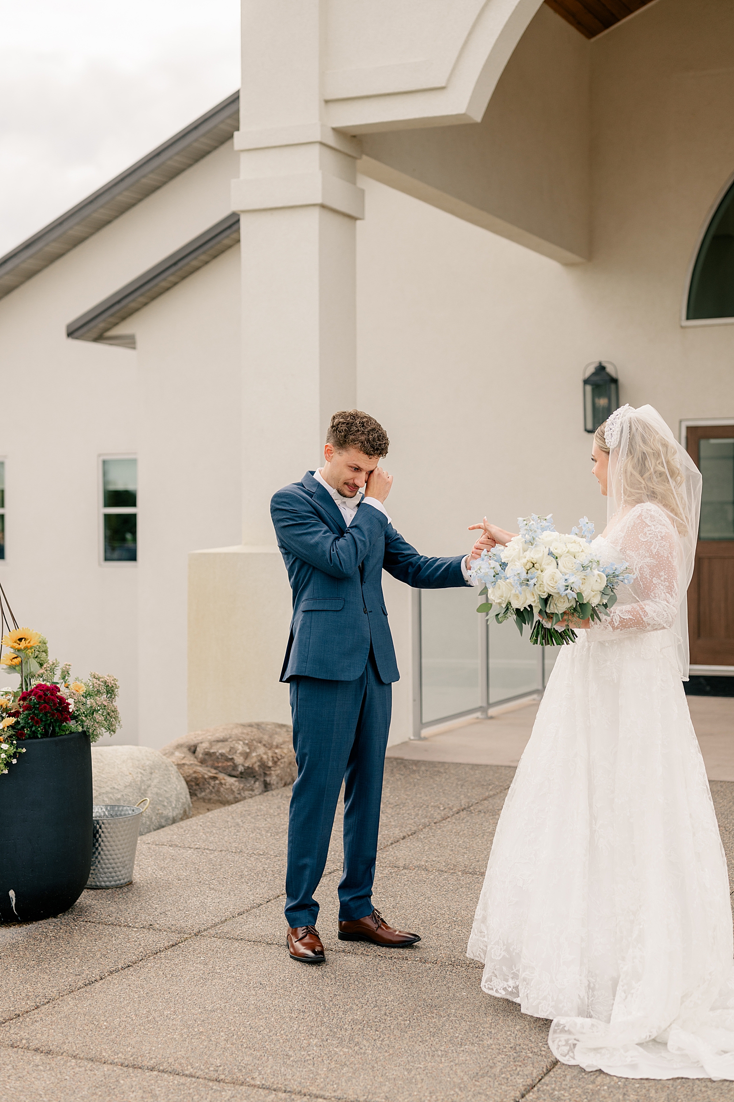 man cries as he sees his fiance in her gown by Minnesota wedding photographer