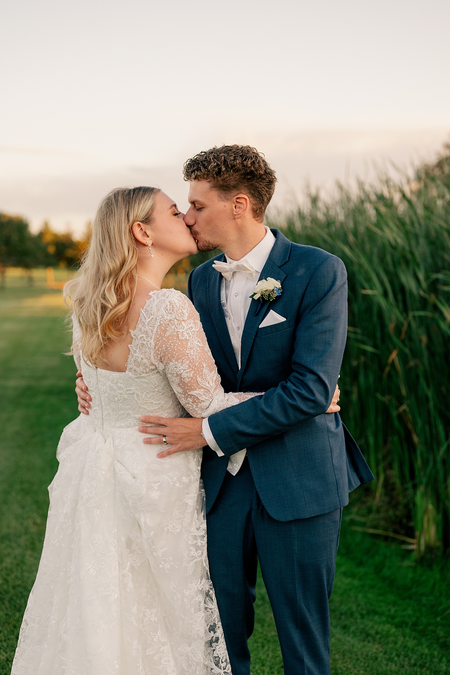man kisses his woman in field for Dream Minnesota Elopement