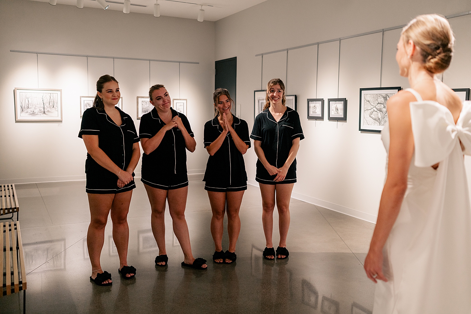bridesmaids in pajamas do first look with bride for black & white wedding