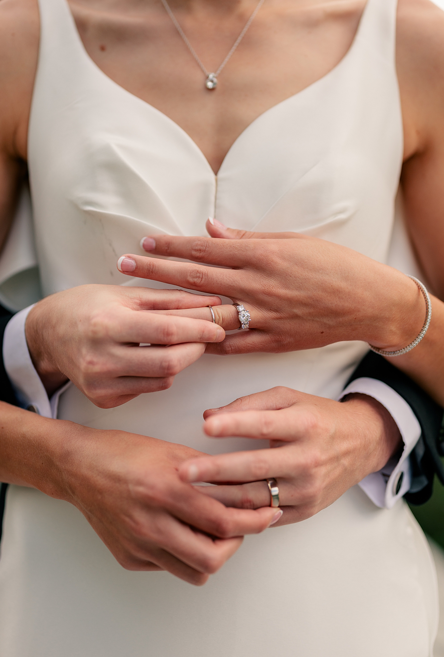 newlyweds show off their new rings at black & white wedding