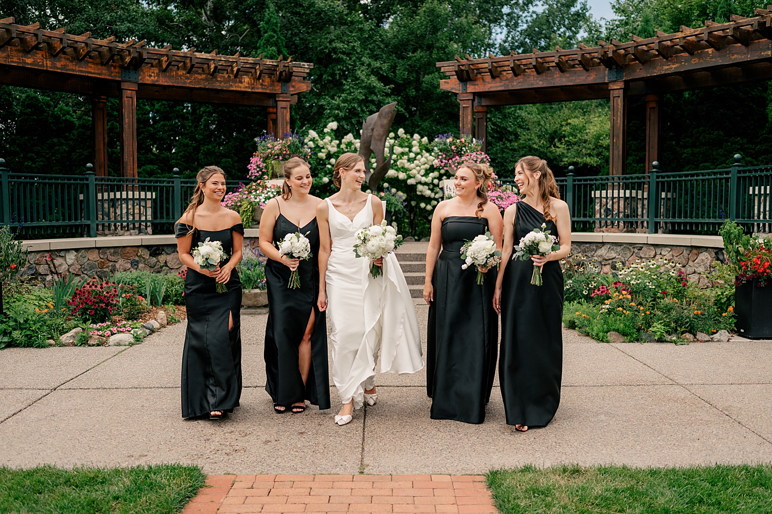 bride walks with her girls down the garden path by Minnesota photographer