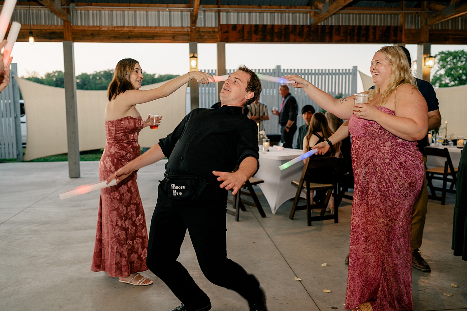 guests dance with light props for reception by Rule Creative Co
