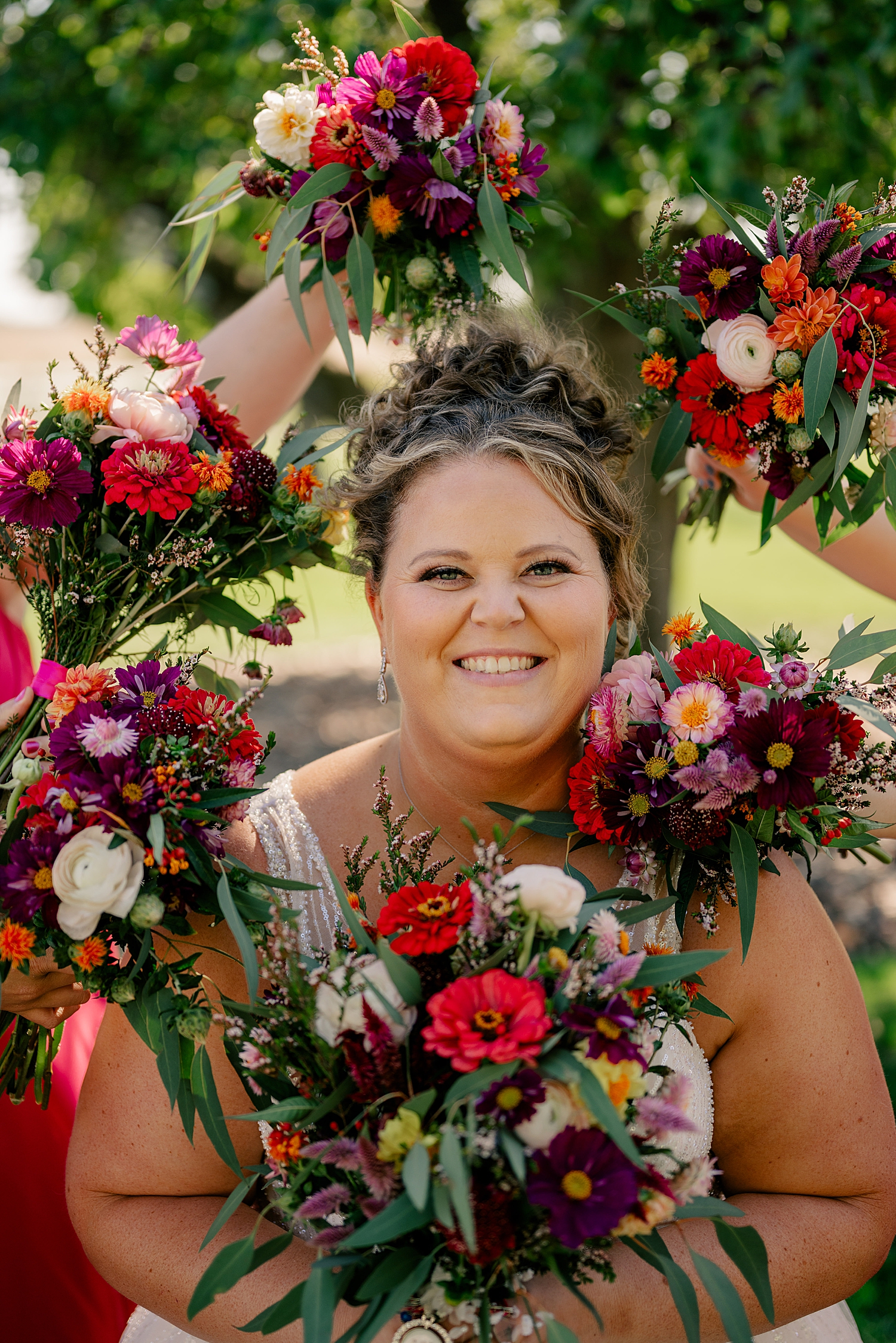 bride is surrounded by flowers at Historic Deglman Farm