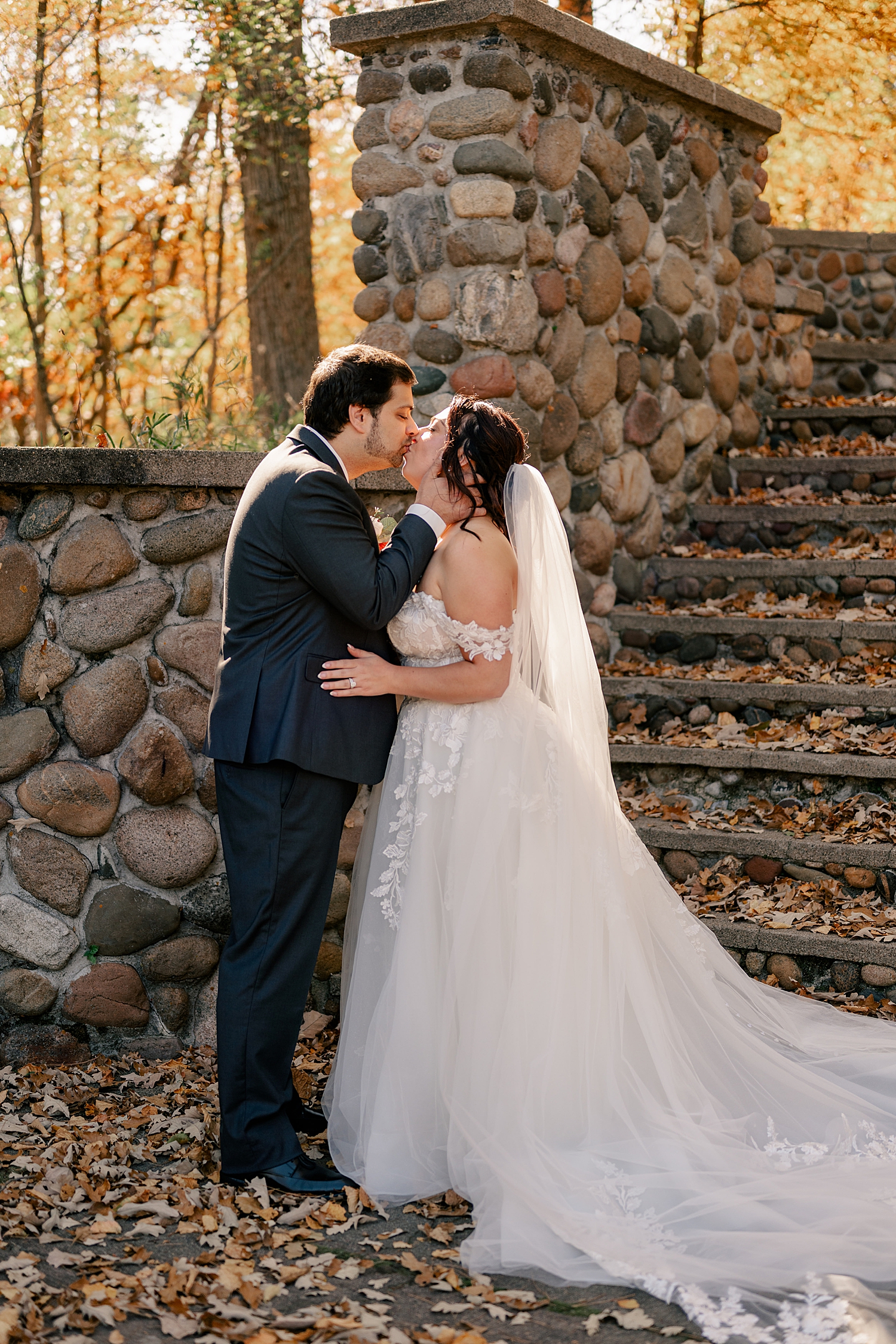 man kisses his bride during first look by Minnesota wedding photographer