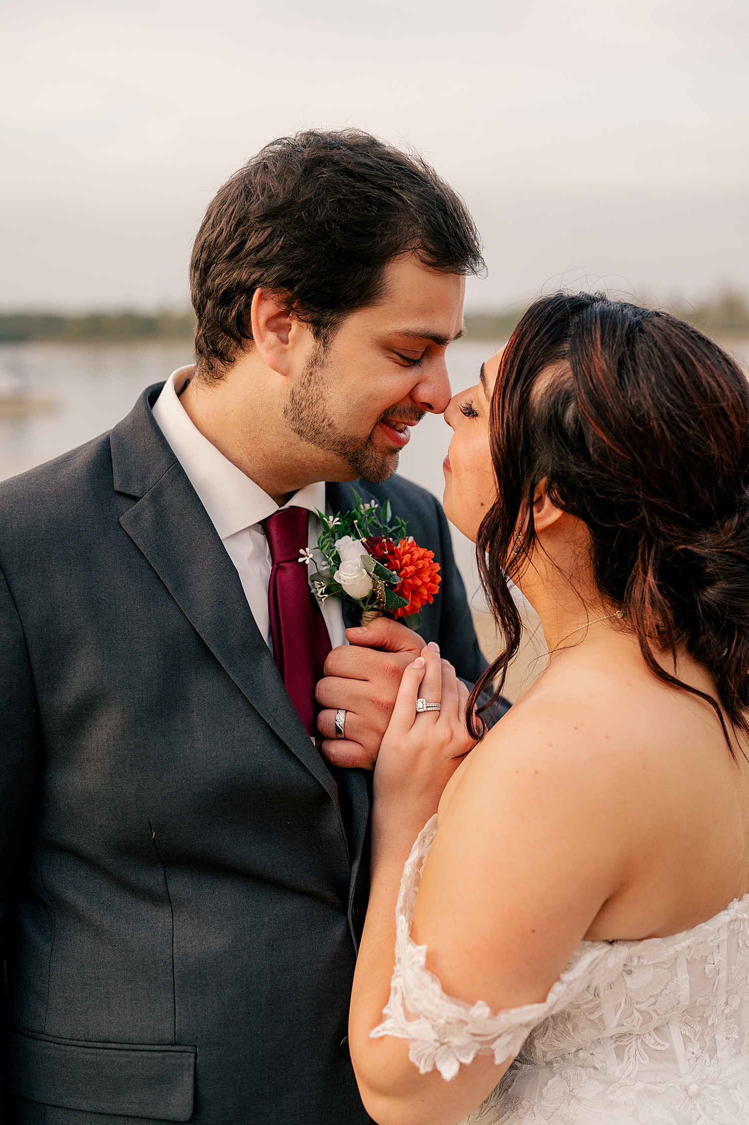 newlyweds nuzzle noses closely by Rule Creative Co