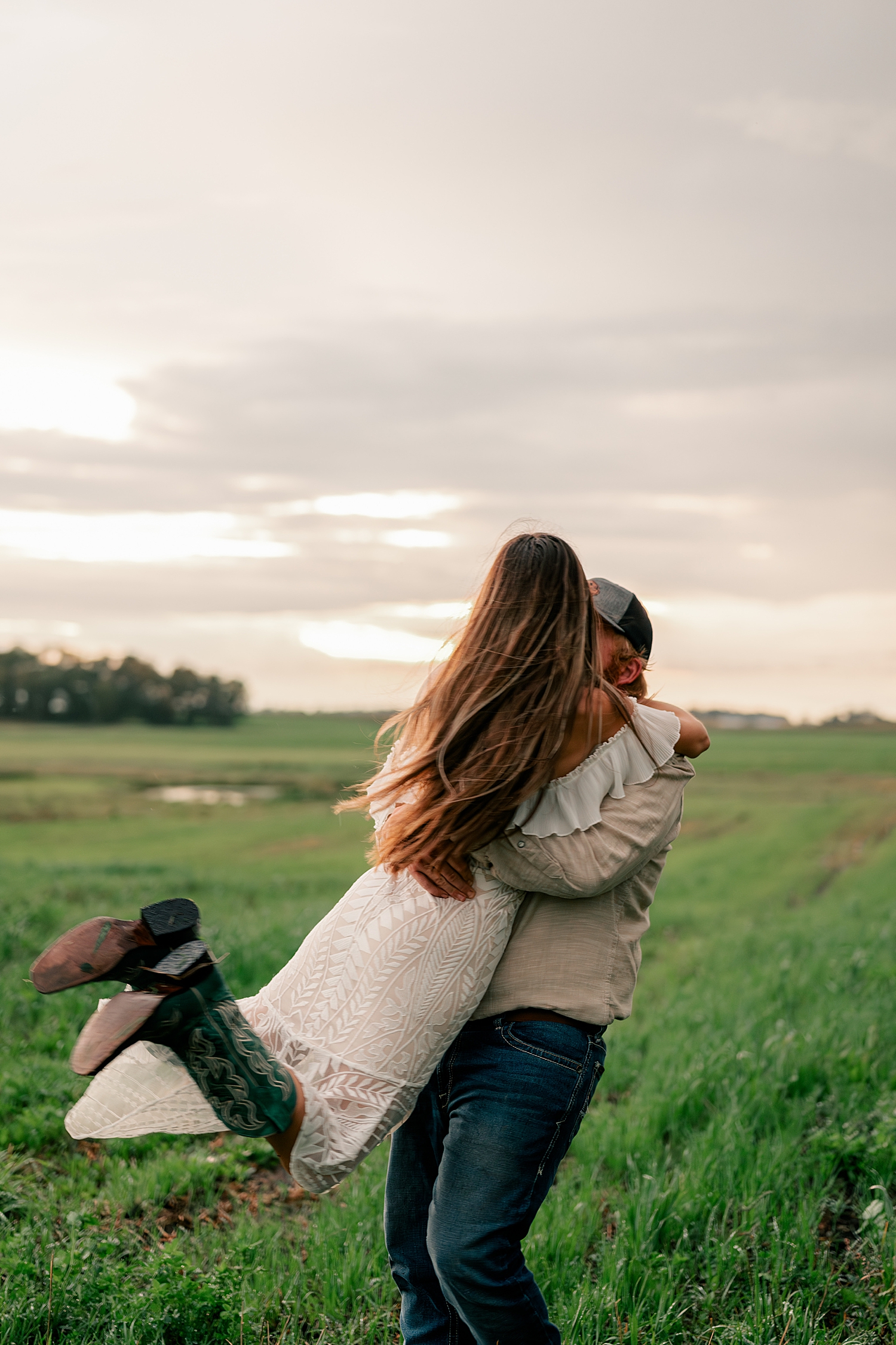 man spins woman in field by Rule Creative Co