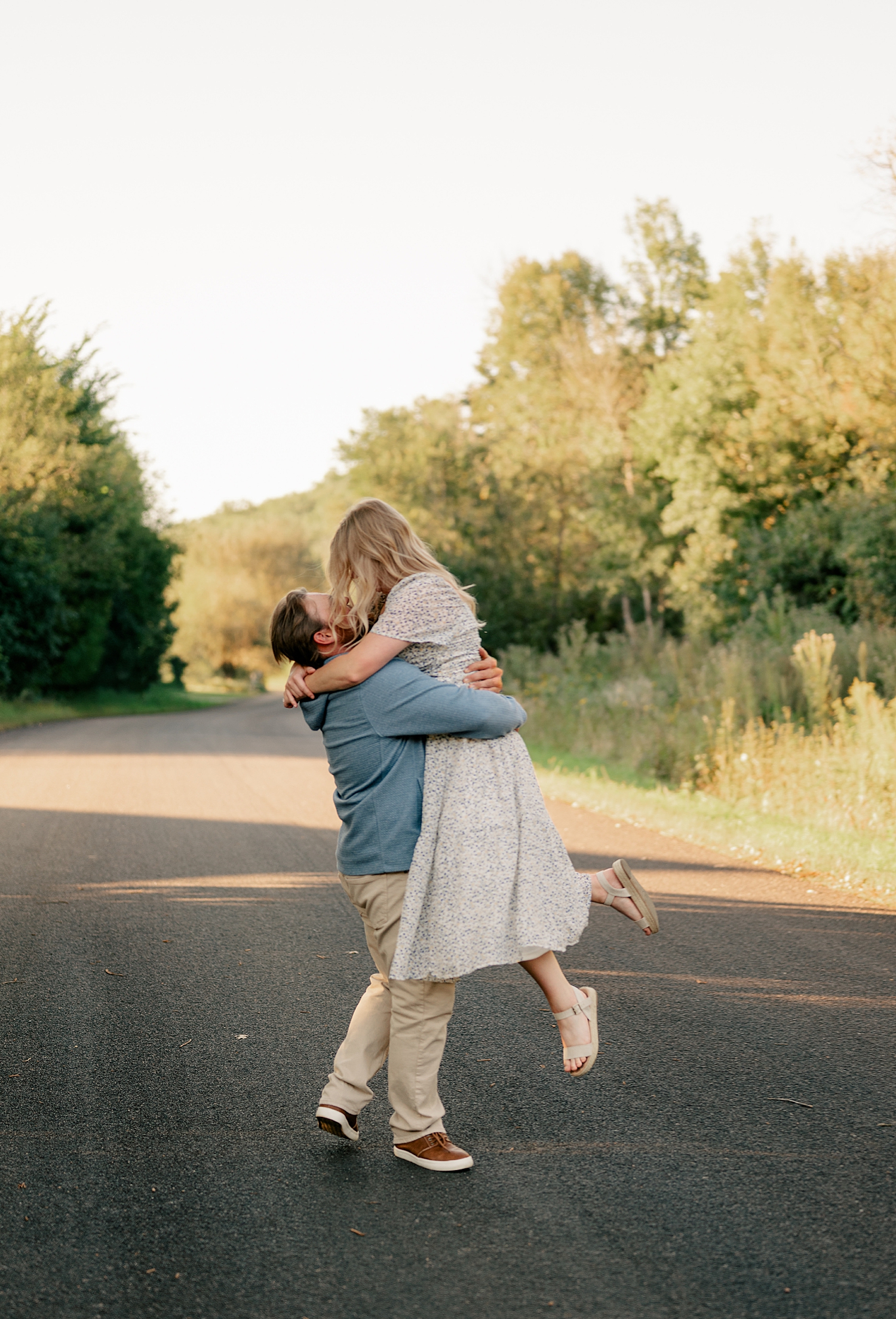 fiance twirls around his bride to be by Minnesota wedding photographer