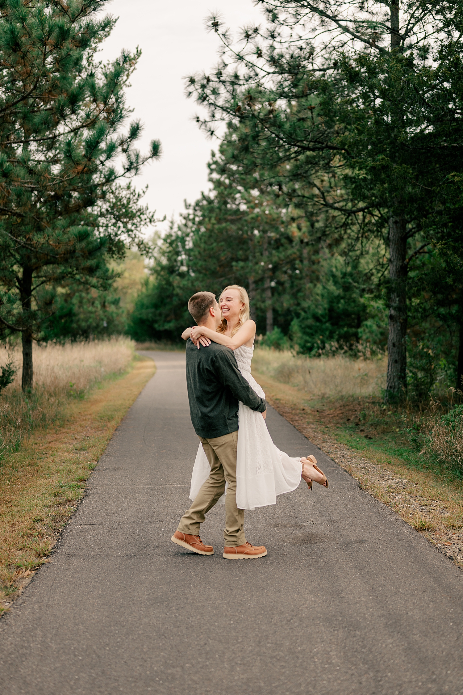 man spins bride-to-be around by Minnesota wedding photographer