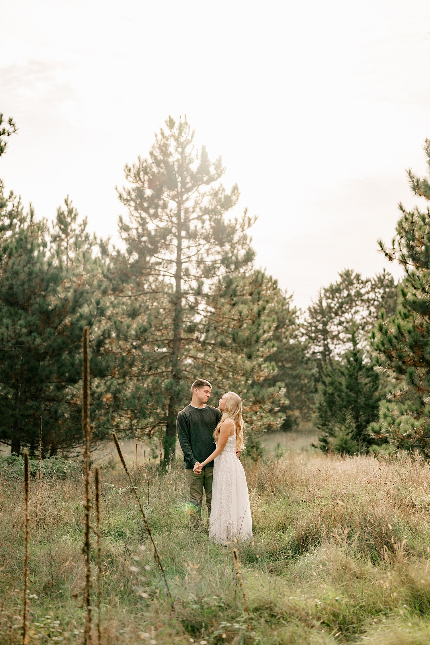 blonde woman in white dress hugs man at Montissippi County Park