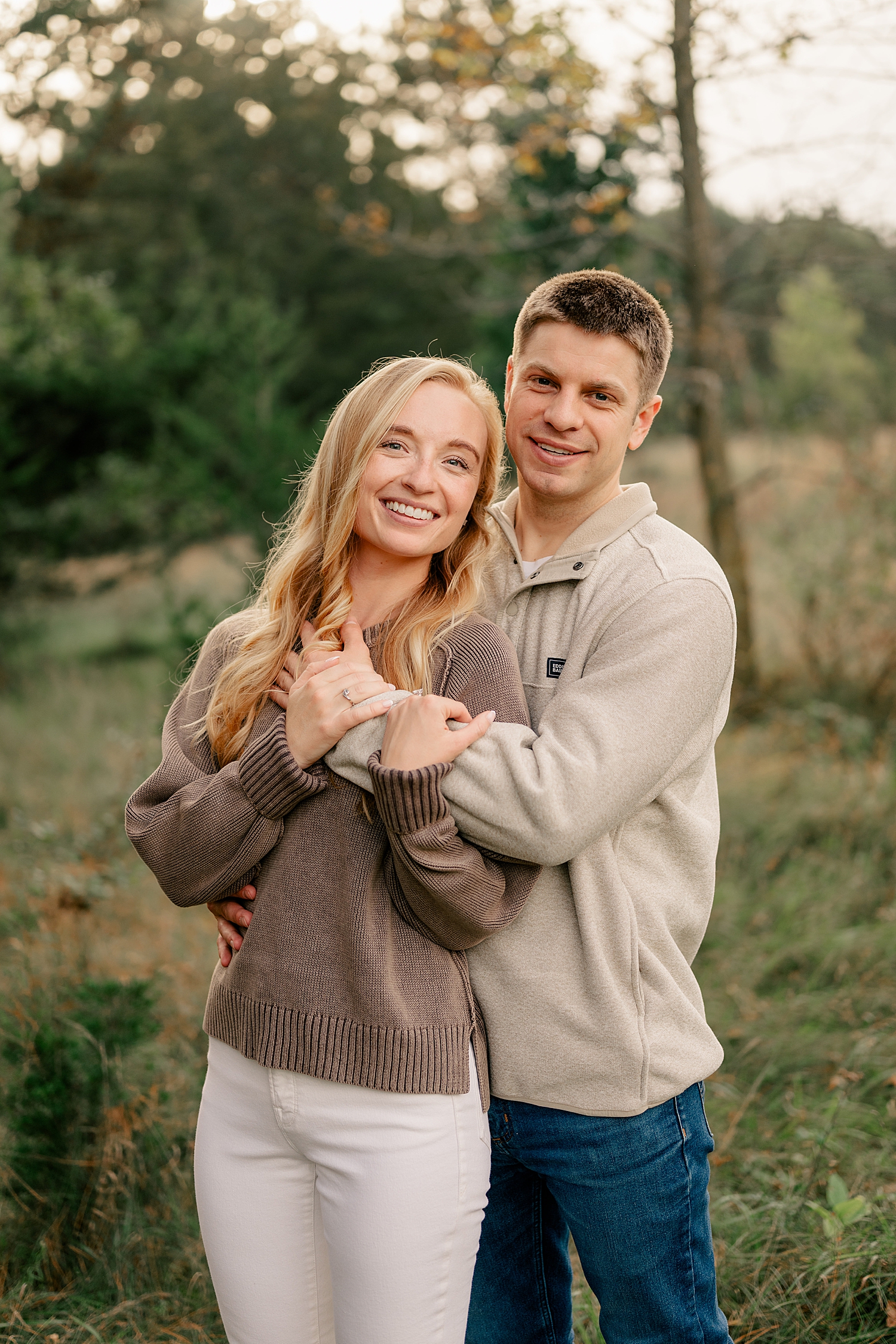 man and woman hold each other in golden hour at Montissippi County Park