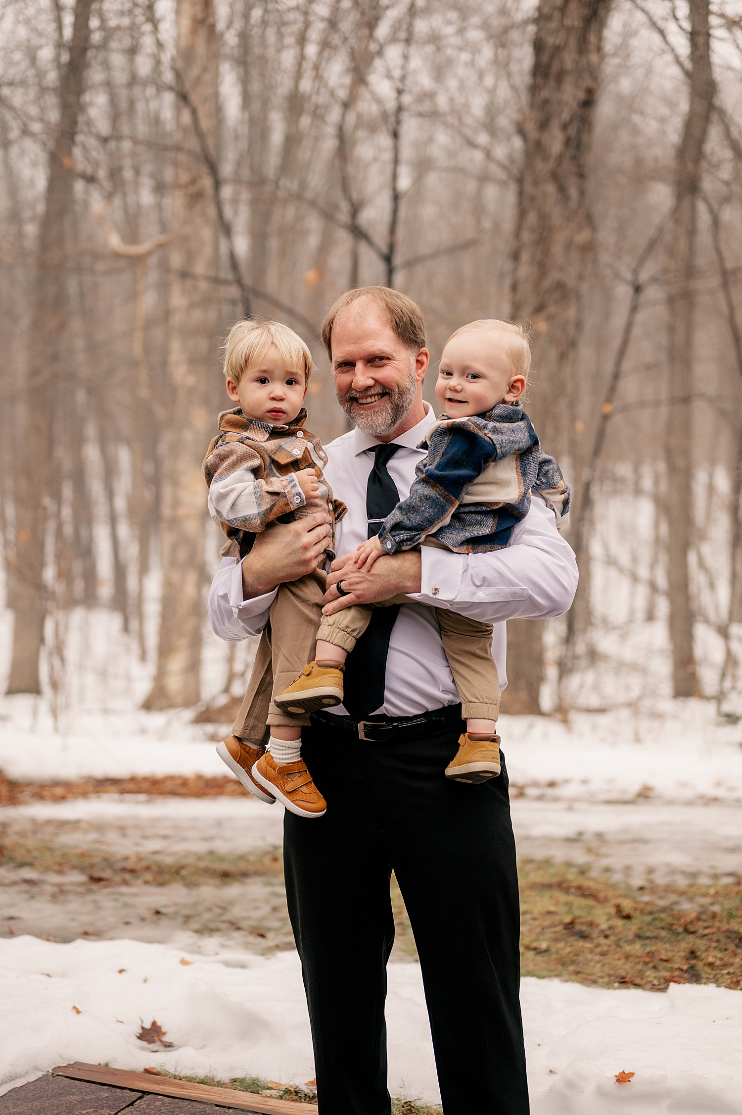 grandfather holds two toddler boys at his wedidng after learning how to keep your elopement personal