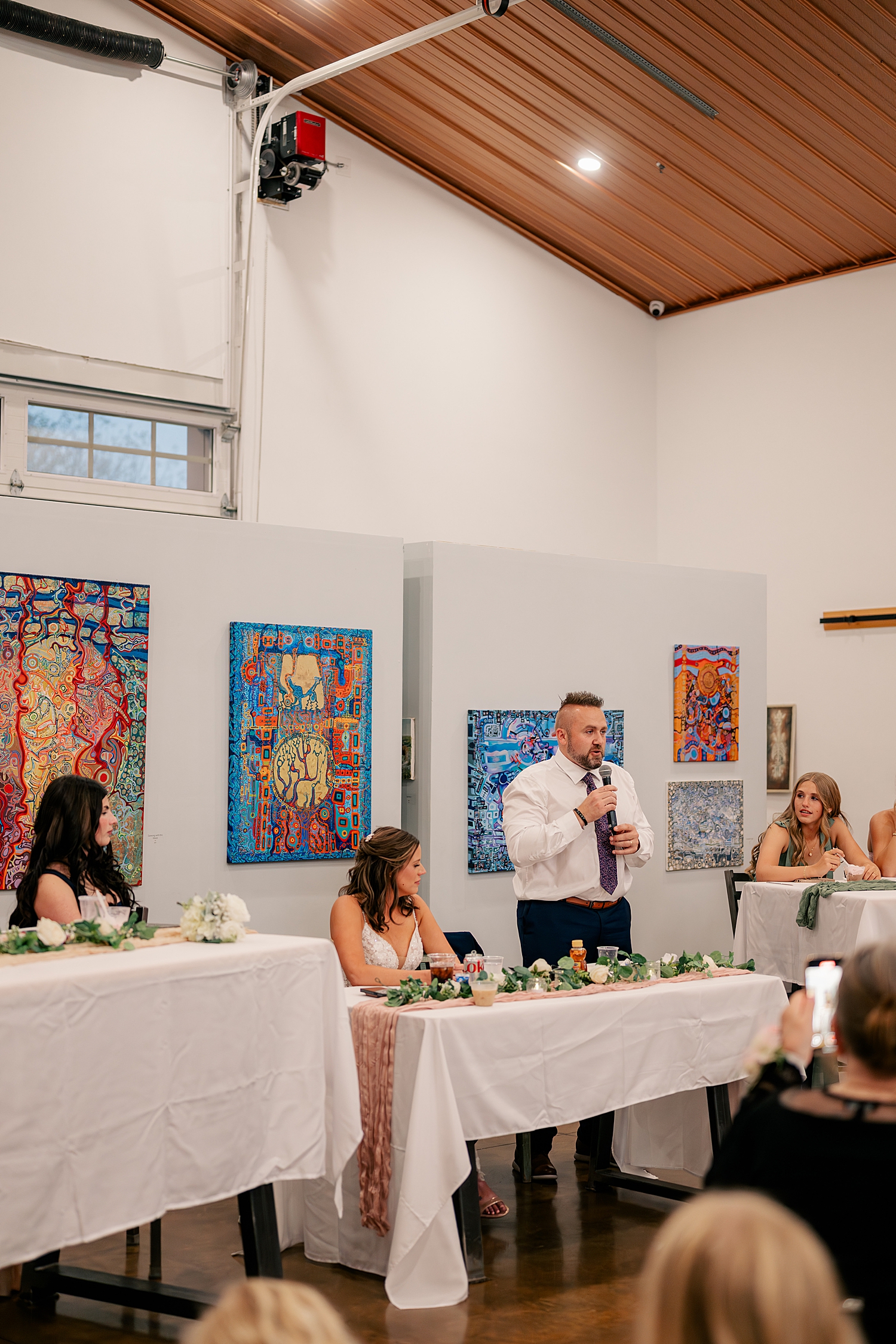 new husband shares a speech with guests at Art in Motion
