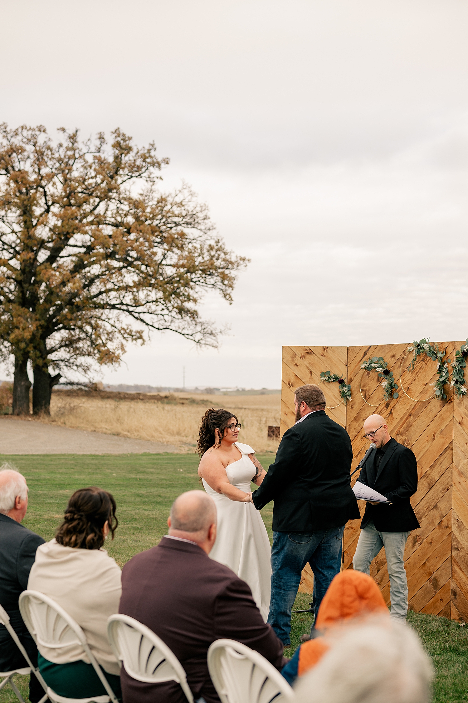 bride and groom say I do at custom alter by Minnesota wedding photographer