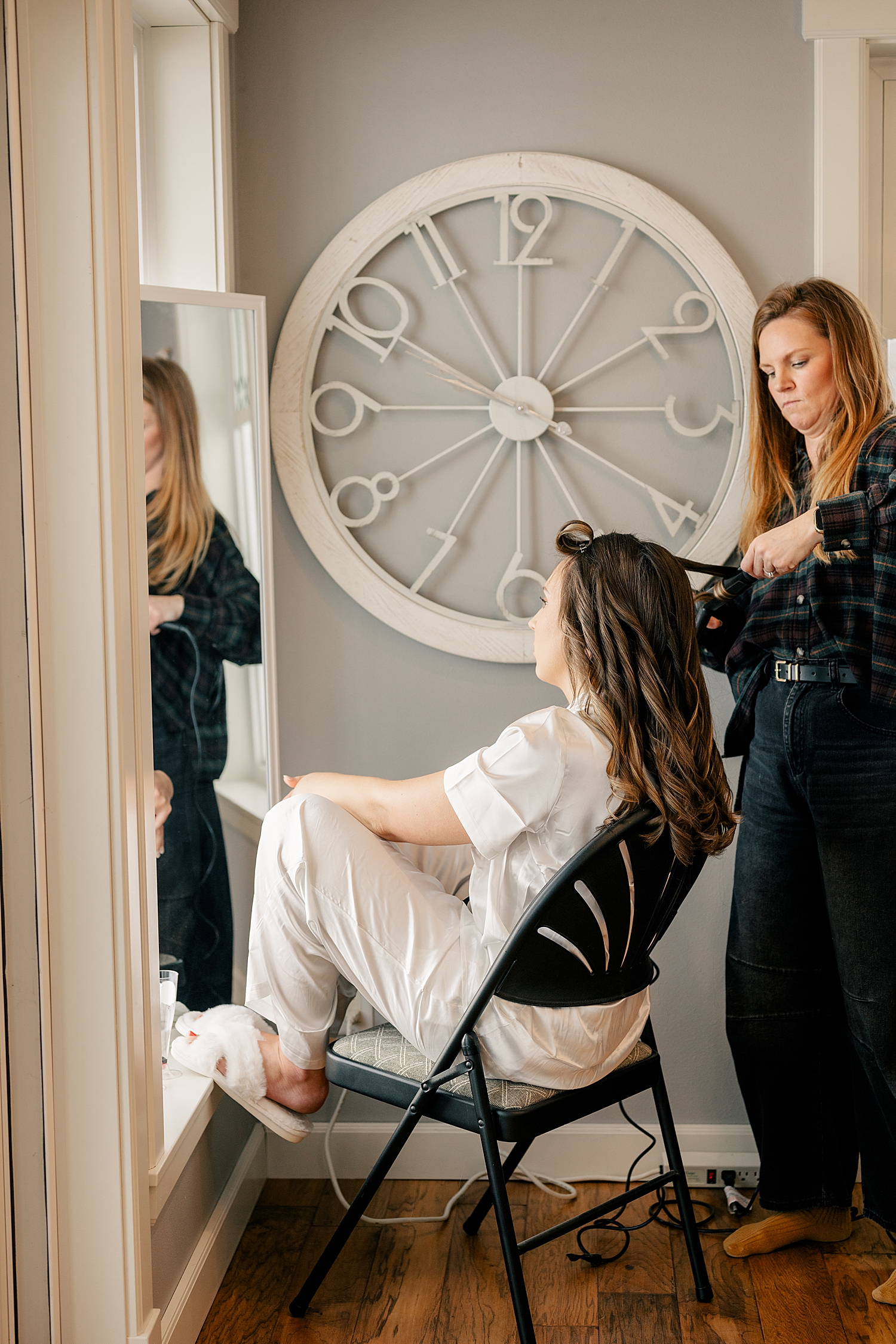 brunette sits in chair for hairstylist by MN elopement photographer