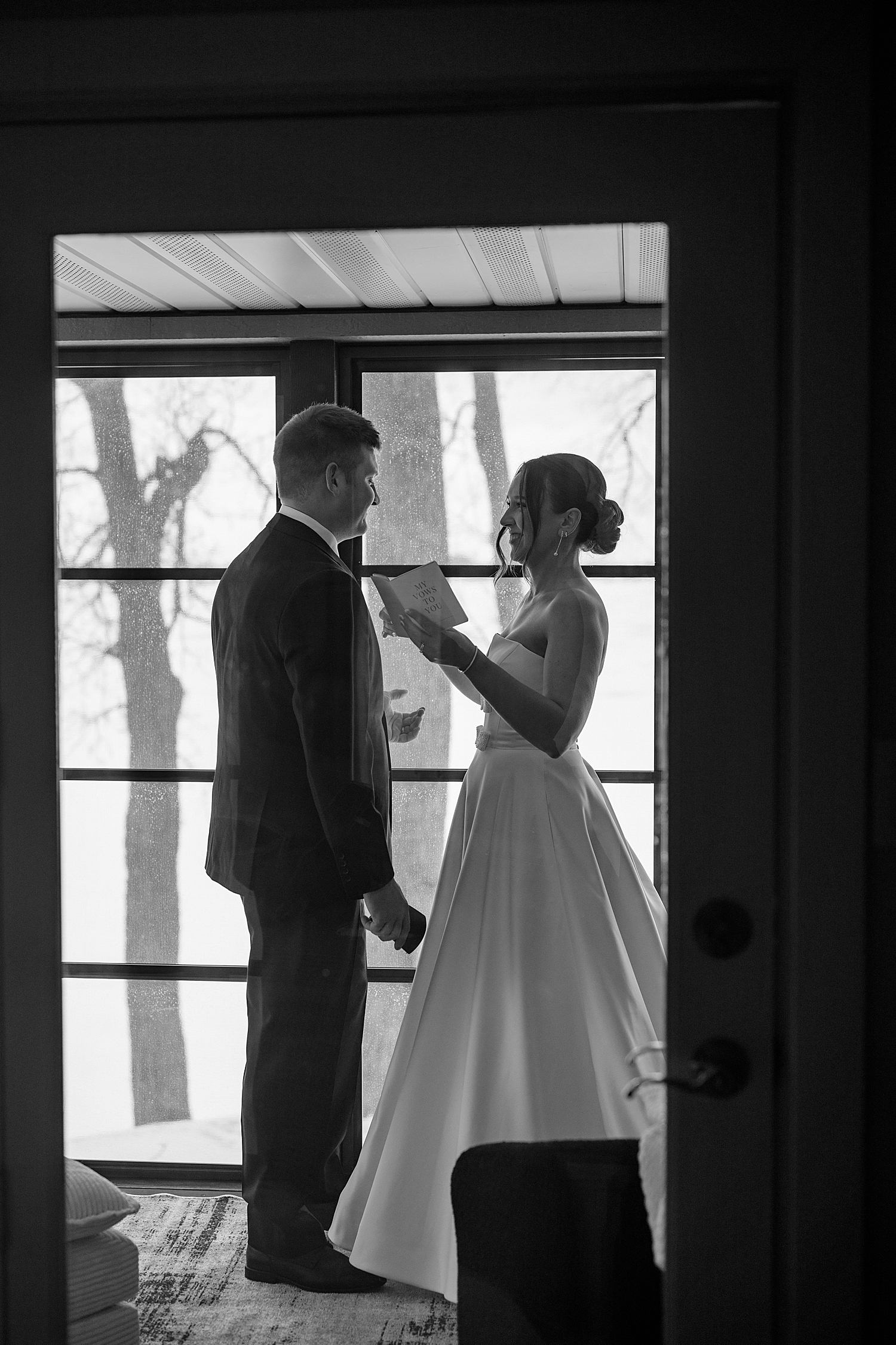 couple share private vows in front of front door by MN elopement photographer