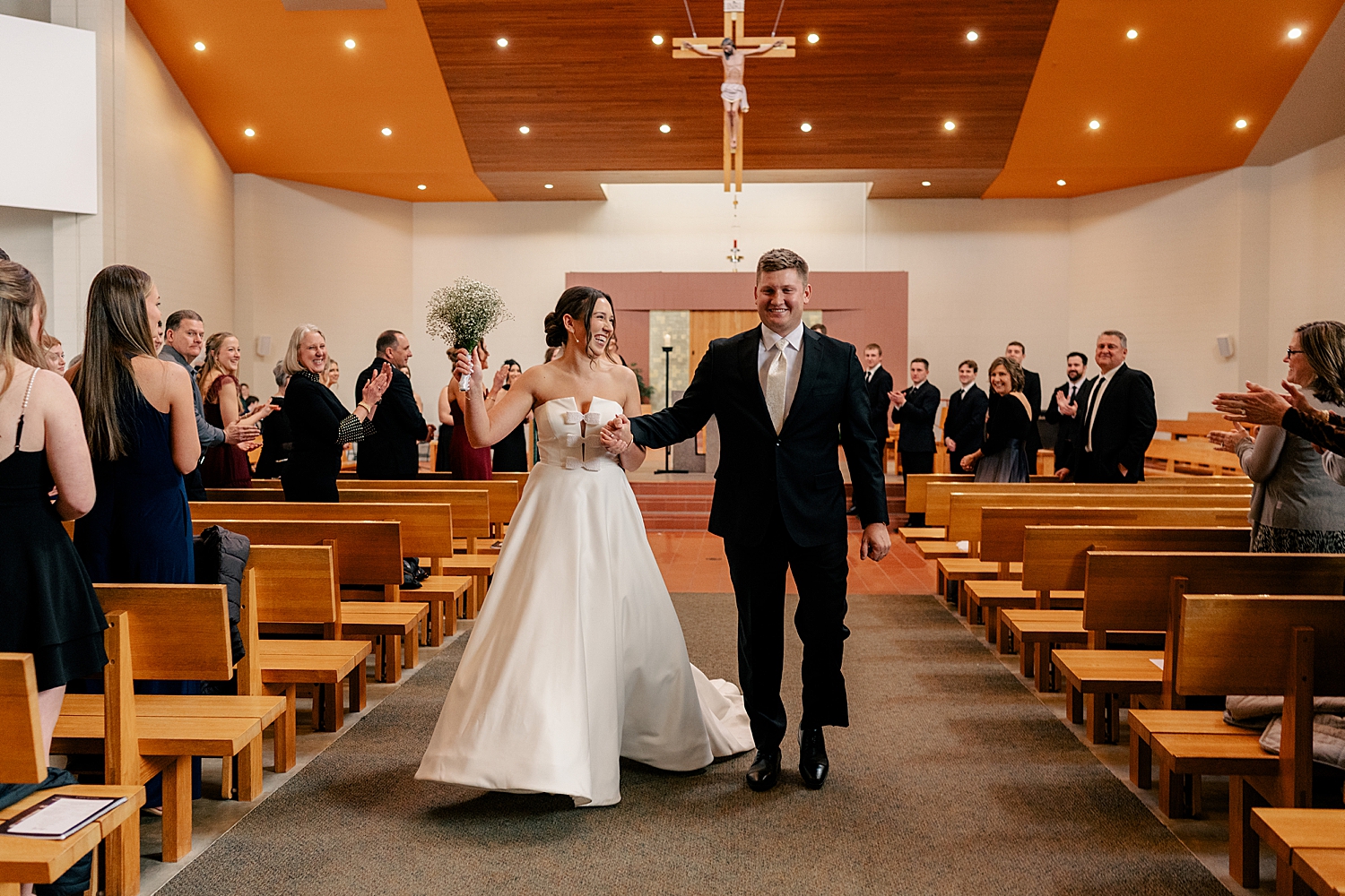 newlyweds walk down the aisle after saying I Do by MN elopement photographer