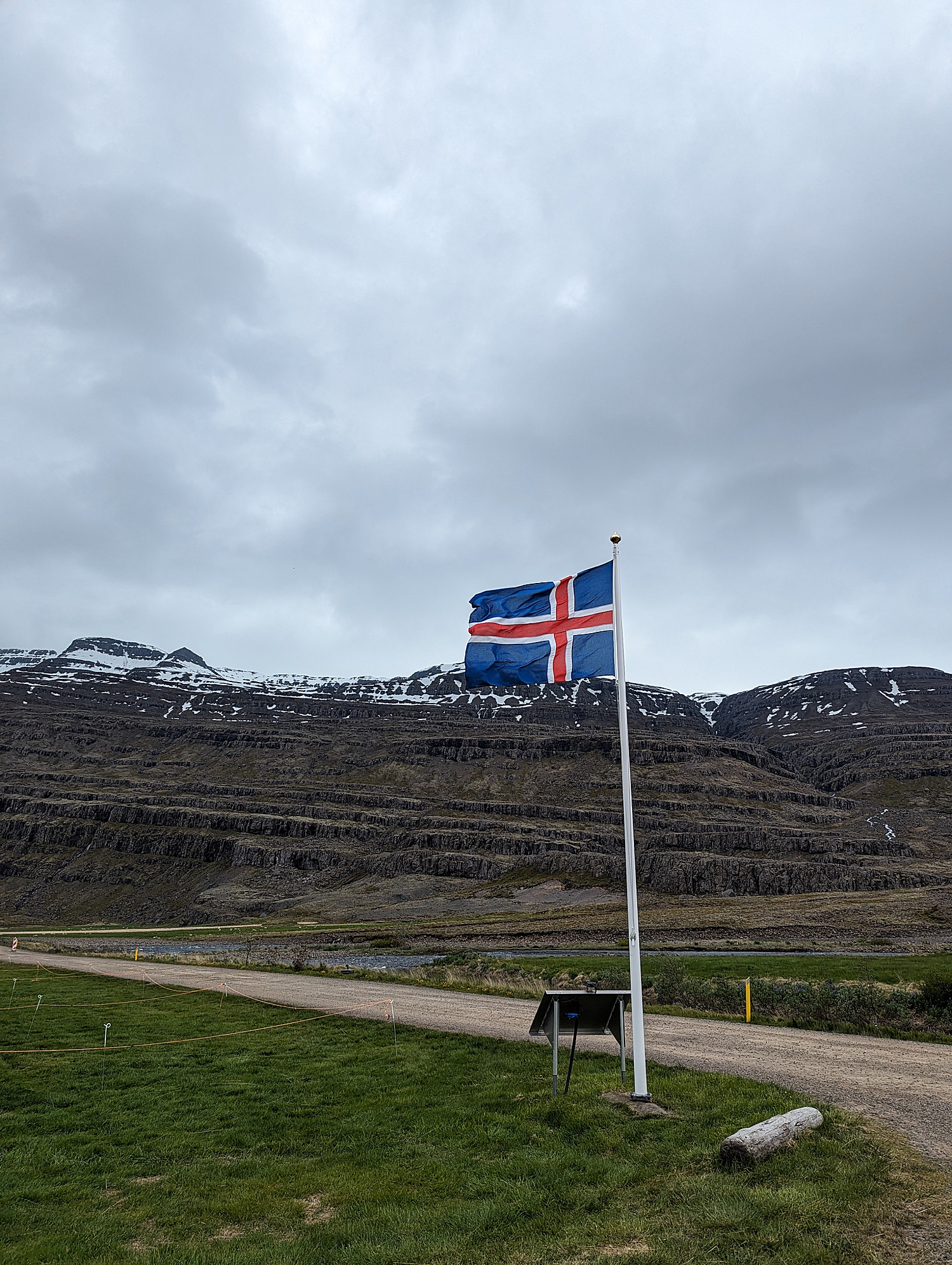 flag in the ground with mountains behind for Iceland elopement